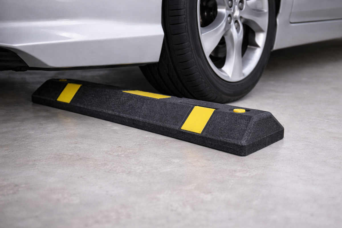 Rubber parking wheel stop installed on garage floor